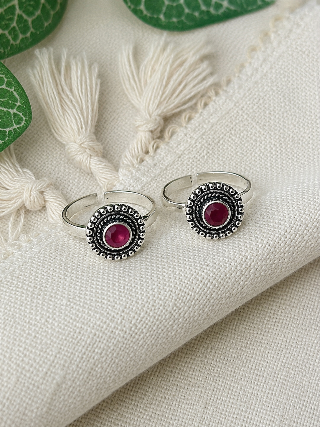 925 silver oxidized beaded halo toe ring pair with maroon stone on tassel fabric