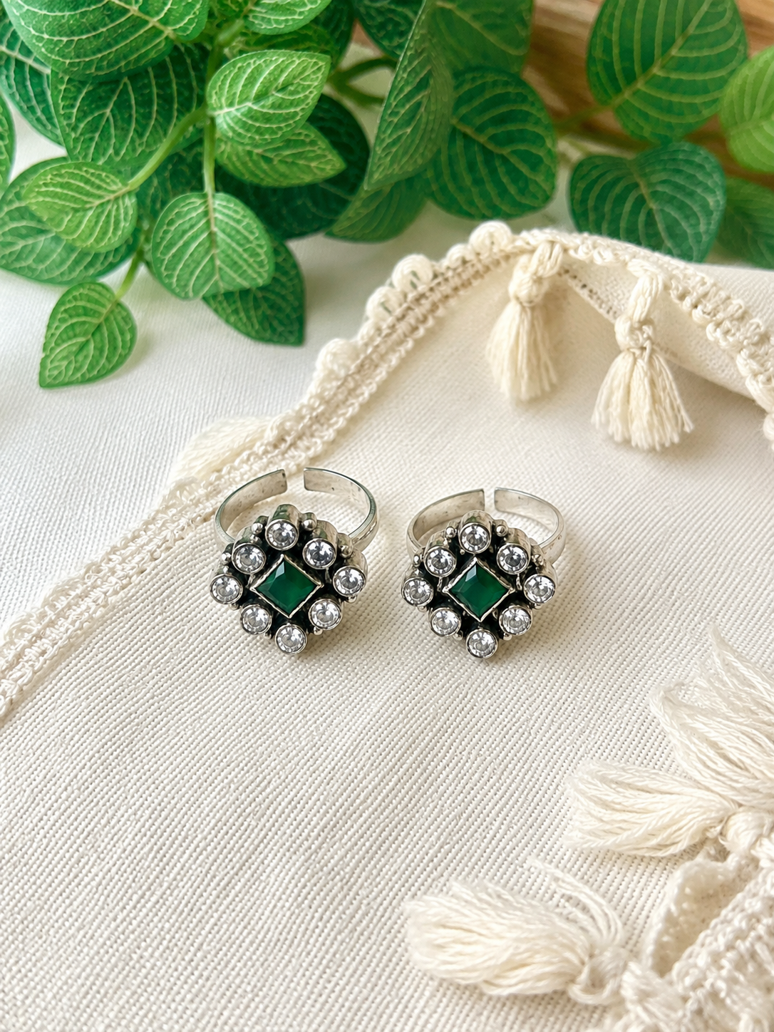 925 silver oxidized square cluster toe ring pair with green stone on linen fabric