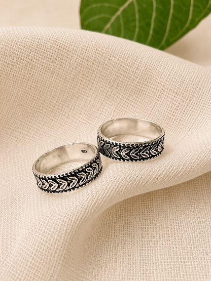 925 silver oxidized peacock-pattern toe ring pair on linen fabric