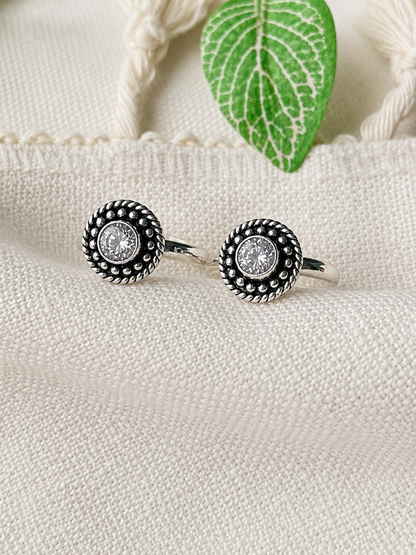925 silver beaded halo toe ring pair with white stone on linen fabric